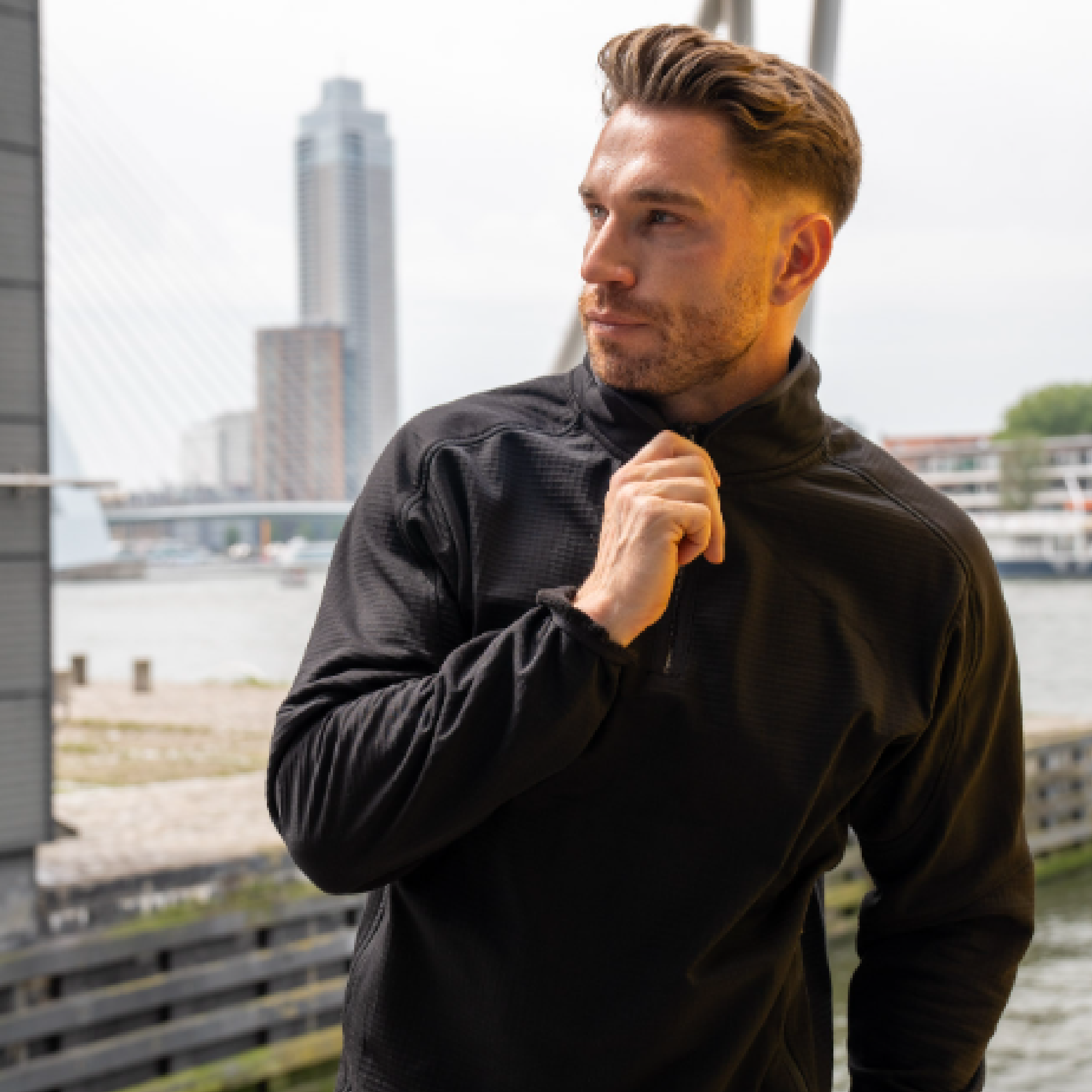 Male model wearing wearing a black work sweater
